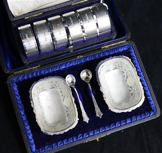 A cased set of six Victorian silver napkin rings by Walker & Hall, Sheffield,1874 and a cased pair of silver salts.